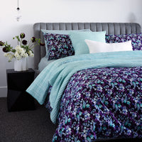 Bambury's Evelyn purple-blue floral print cotton quilt cover set with light blue throw blanket and decor cushions