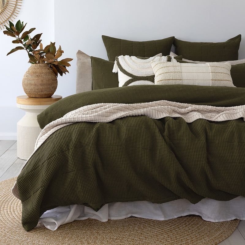 Bambury's Samira dark green waffle cotton quilt cover set with neutral throw blanket and decor cushions