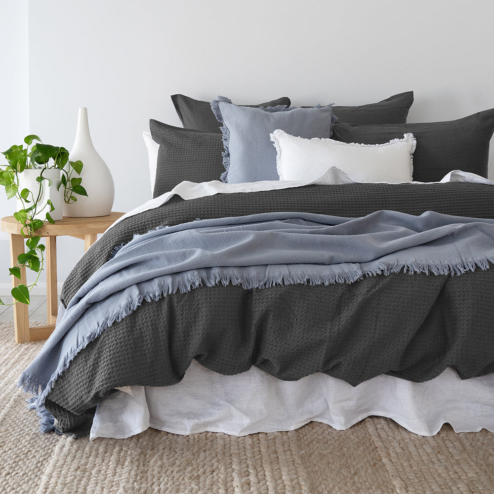 Bambury's Melville dark grey waffle cotton quilt cover set with blue throw blanket and decorative pillow